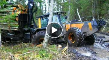 Valtra forestry tractor with big trailer in wet forest