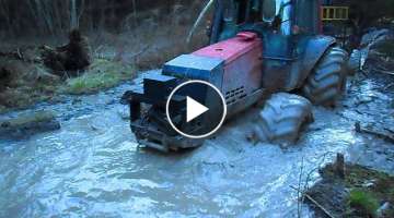 Valtra forestry tractor in wet forest , difficult conditions